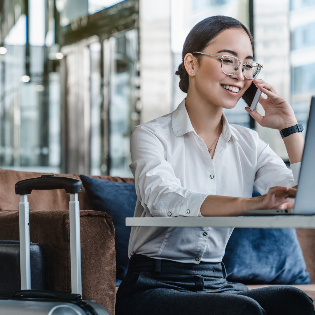 Dwellworks Living Corporate Housing - Woman on Phone at Airport - Rotational Assignment Housing for Group Travel